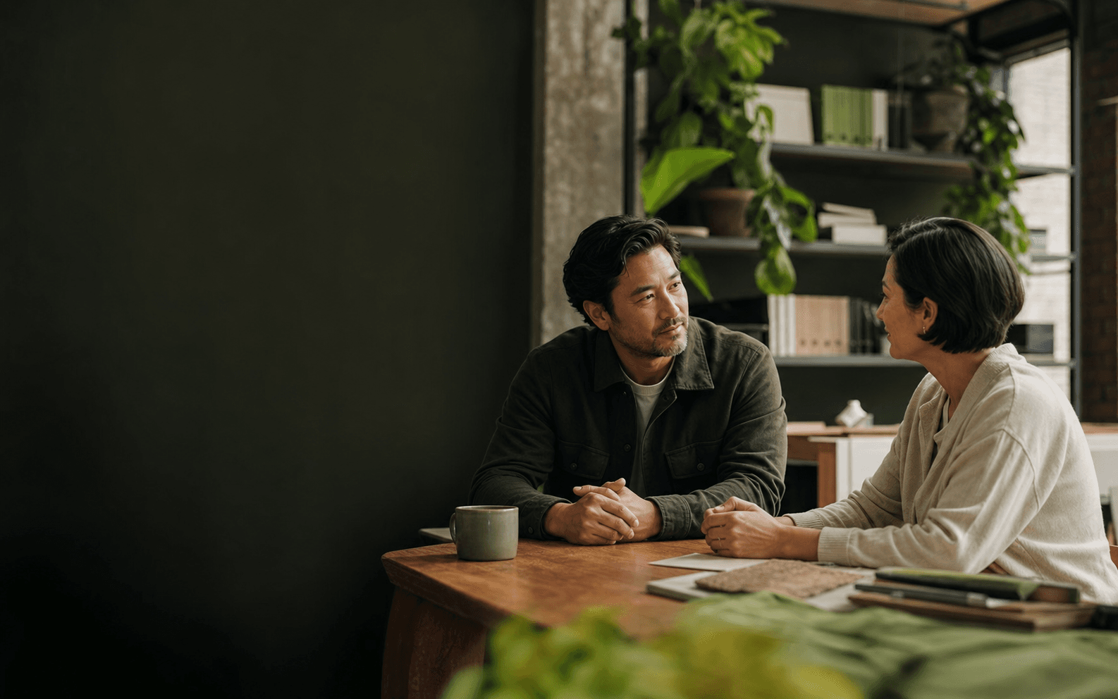 A trusted advisor speaking with a business owner in her workplace